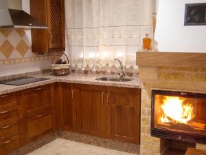 a kitchen with a fireplace in the middle of it at Idyllic House in Yegen with Mountain View in Yegen