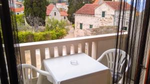 a white chair sitting on a balcony with a view at Comfortable Studio in Sumartin with Sea View - 22 m² in Sumartin