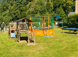 an outdoor playground with an orange and blue play equipment at Maison cosy à Cauterets avec vue sur les montagnes et jardin in Cauterets