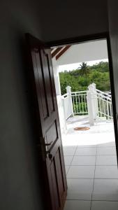 an open door with a view of a balcony at Appartement charmant à Petit-Canal in Petit-Canal +19 photos