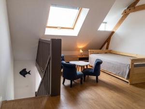 a bedroom with a bed and a table and chairs at Maison chaleureuse à Erquy avec jardin et parking in Erquy