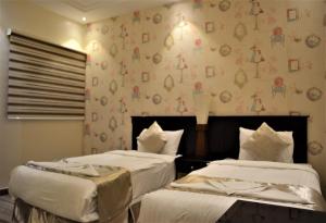 Lova arba lovos apgyvendinimo įstaigoje Saba Ohod For Hotel Suites