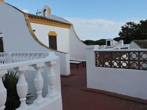a white house with a white fence and a balcony at Spacious Villa in Conil de Frontera with Private Pool in Roche