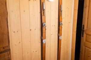 a wall of wooden panels with locks on it at Studio confortable à Taninges, 25 m² avec vue sur jardin in Taninges