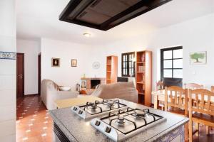 a kitchen and living room with a stove top oven at Spacious Villa in Conil de Frontera with Private Pool in Roche