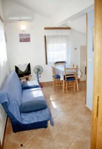 a living room with a couch and a table at Sea View Apartment in Prvić Luka, 46m², Terrace in Prvić Luka