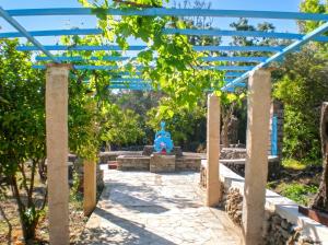 a fountain in the middle of a garden at Picturesque Villa in Limnos + Enclosed Garden + Sea View in Lemnos