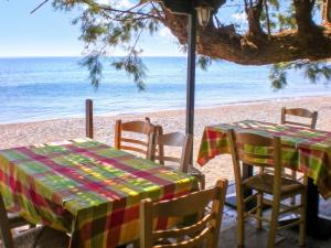 a table and chairs on the beach with the ocean at Picturesque Villa in Limnos + Enclosed Garden + Sea View in Lemnos