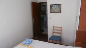 a bedroom with a bed and a chair and a door at Charming Apartment in Gdinj + Garden in Gdinj +25 photos
