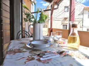 a table with a plate and a vase on a table at Welcoming apartment in Medulin - 75 sqm with view in Medulin