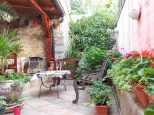 a patio with a bench and a table and some plants at Welcoming apartment in Medulin - 75 sqm with view in Medulin