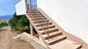 a staircase leading up to a building with the ocean at Charming Apartment with Sea View, Gdinj, 70 m², Garden in Gdinj