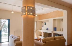a living room with a couch and a pillar at Charming Villa with Sea View in Karistos in Karistos