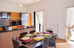 a kitchen with a table with chairs and a dining room at Charming Villa with Sea View in Karistos in Karistos