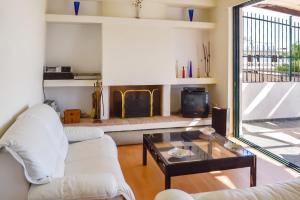 a living room with a white couch and a fireplace at Charming Villa with Sea View in Karistos in Karistos