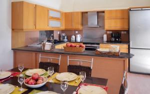 a kitchen with a table with plates and fruit on it at Charming Villa with Sea View in Karistos in Karistos