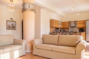 a living room with two couches and a kitchen at Charming Villa with Sea View in Karistos in Karistos +44 photos