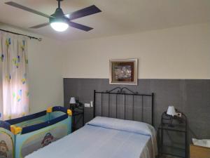 a bedroom with a bed and a ceiling fan at House with private pool in Aguilas, sea & pool view in Águilas