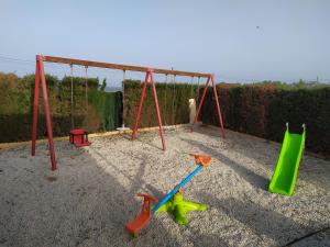 a playground with a swing set and toys in the sand at House with private pool in Aguilas, sea & pool view in Águilas