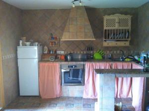a kitchen with a refrigerator and a stove top oven at House with private pool in Aguilas, sea & pool view in Águilas