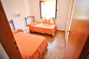 a small room with two beds and a window at Charming House in Vieste with Shared Pool and Terrace in Vieste