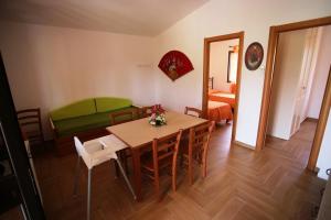 a room with a table and chairs and a couch at Charming House in Vieste with Shared Pool and Terrace in Vieste