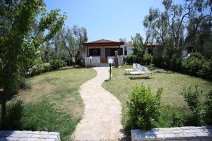 a garden with a house and a path at Charming House in Vieste with Shared Pool and Terrace in Vieste +27 photos