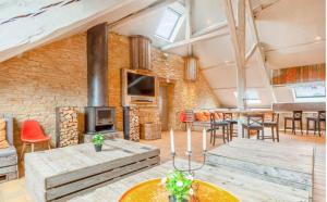 a large living room with a brick wall at Spacious villa in Florenville with private pool in Florenville