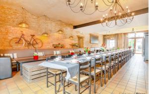 a dining room with a long table with chairs at Spacious villa in Florenville with private pool in Florenville