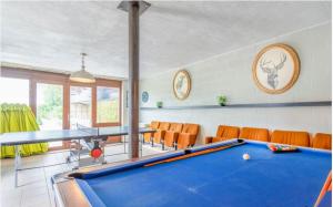 a billiard room with a pool table and chairs at Spacious villa in Florenville with private pool in Florenville
