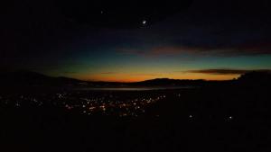 a view of a city at night with the moon at Elegant Villa with Sea View in Politika in Politika