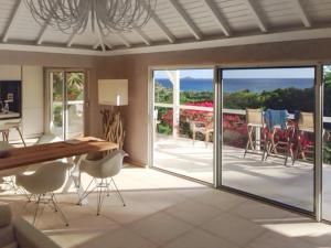 a dining room with sliding glass doors and a patio at Heavenly Villa in Gustavia with Private Pool in Gustavia