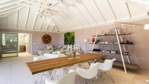 a living room with a wooden table and white chairs at Heavenly Villa in Gustavia with Private Pool in Gustavia
