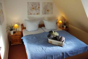 a bedroom with a bed with a basket on it at Spacious House in Sylt-Ost, Garden in Tinnum