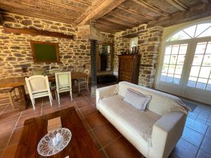 a living room with a couch and a table at Cottage Normand in Lison