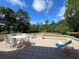 a patio with a table and chairs on a patio at Cottage Normand in Lison