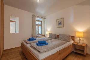 a bedroom with a large bed with blue pillows on it at Ropferhof in Buchen