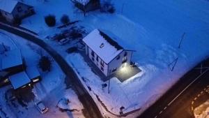 an aerial view of a house in the snow at night at Apartma Julia in Semič