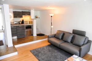 a living room with a couch and a kitchen at Appartement contemporain à Cognac, 50 m² - Parking. in Cognac
