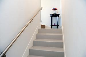 a staircase in a house with white walls at Appartement contemporain à Cognac, 50 m² - Parking. in Cognac