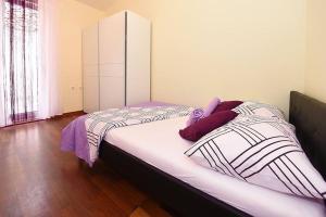 a bedroom with a large bed with a white cabinet at Family Villa in Solin with Pool in Solin