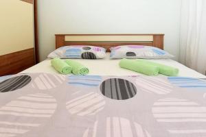 a bed with two pillows on it with at Family Villa in Solin with Pool in Solin