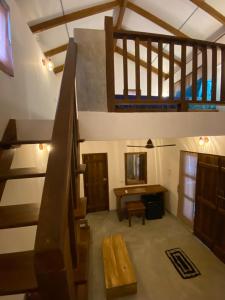 a room with stairs and a table and a desk at Starfish Cabbana in Arugam Bay