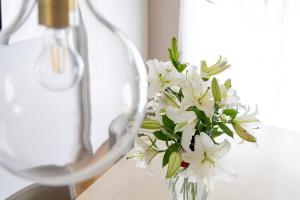 a vase filled with white flowers sitting on a table at HABi-Sekido5 in Wakayama