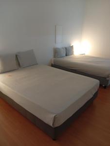 two beds sitting next to each other in a room at Residencial Sky Lounge in Lisbon +10 photos