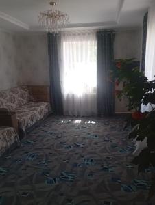 a living room with a couch and a window at Adelina in Kyzart