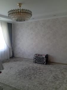 a living room with a chandelier and a room with a unintention at Adelina in Kyzart