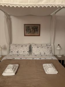 a bedroom with a bed with two towels on it at Art & Breakfast in Ripabottoni