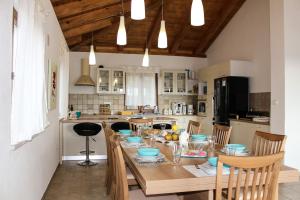 a kitchen with a wooden table with chairs and a dining room at Charming Villa near Žminj with Private Pool in Žminj