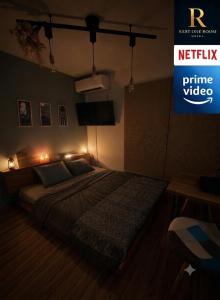 a bedroom with a bed with lights and a tv at Rest one room大阪-阪急梅田駅から電車と徒歩で15分-神崎川駅から徒歩7分- in Osaka